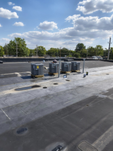 Multiple commercial AC condenser units installed on a rooftop by Aaron's Affordable Ac in Indianapolis, IN.