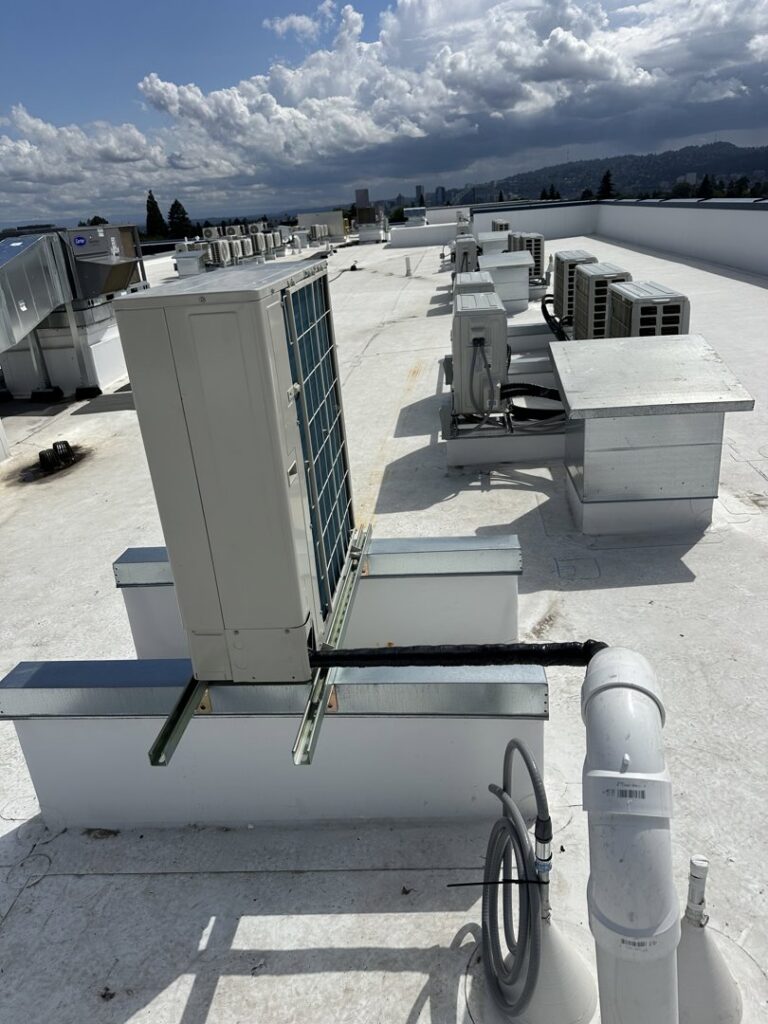 Multiple commercial air conditioning units installed on a rooftop by A's Heating and Cooling LLC in Portland, OR.