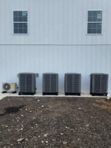 Multiple commercial air conditioning units installed along a building by Xtreme Heating & Cooling in Tulsa, OK