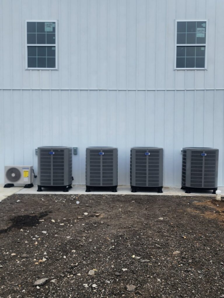 Multiple commercial air conditioning units installed along a building by Xtreme Heating & Cooling in Tulsa, OK