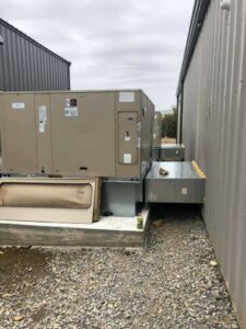 Multiple commercial HVAC units installed outside a building by Griffin's Heating & Air in Tulsa, OK.