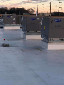 Multiple Carrier WeatherMaker commercial HVAC units installed on a large rooftop by Air Quality, LLC in Cranston, RI