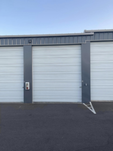 Multiple commercial roll-up garage doors installed by DOOR TECHS for a business in Salem, OR.