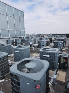 Numerous commercial rooftop AC condenser units maintained by EPCTL Heating and Cooling in Byers, CO.