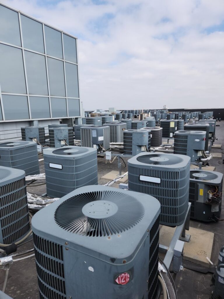 Numerous commercial rooftop AC condenser units maintained by EPCTL Heating and Cooling in Byers, CO.
