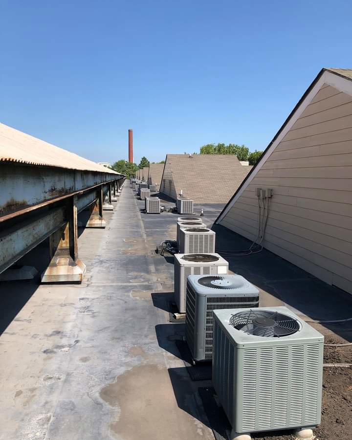 A row of multiple commercial rooftop AC condenser units installed by TAG Heat N Air in North Little Rock, AR.