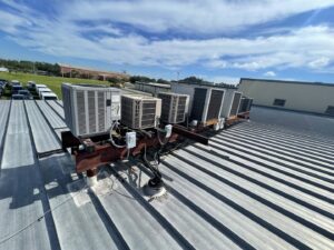 Multiple commercial rooftop HVAC units, including York brand, maintained by Blue Air Heating and Cooling in Orlando, FL.