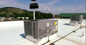 Multiple commercial rooftop HVAC units on a building, serviced by One Way Service Pros in Deadwood, SD.
