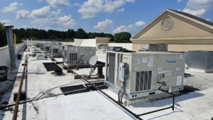Several commercial rooftop HVAC units installed on a building by Peak Seasons HVAC in Raleigh, NC.