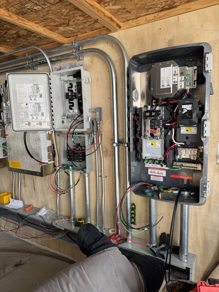 Multiple electrical inverters and conduit installed on a wall by Pioneer Electric LLC in West Valley City, UT.