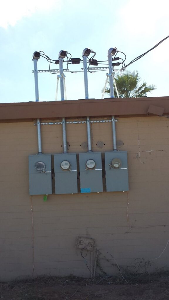 Installation of multiple electrical meters and conduits on the exterior of a building by EV Electric LLC in Mesa, AZ
