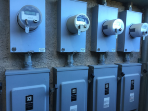 Multiple electrical meters and service panels installed on an exterior wall by GDS Electric Inc. in Colorado Springs, CO