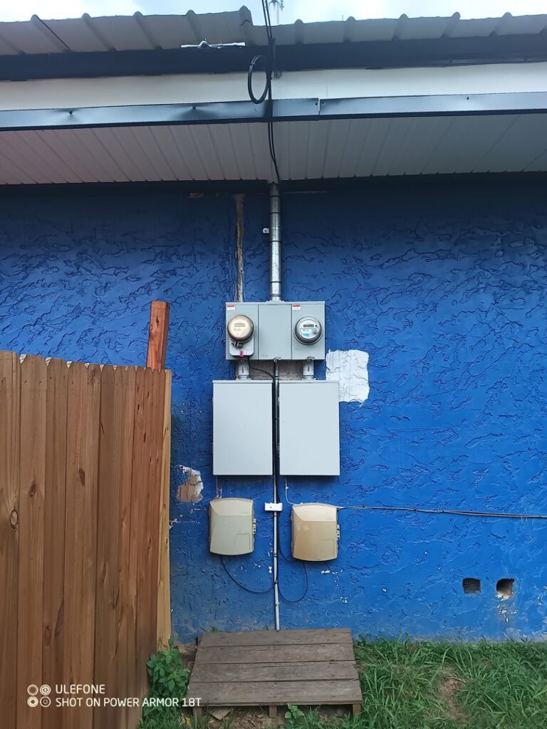 Multiple electrical meters and service boxes installed on an exterior wall by Elemental Electrical in Chattanooga, TN.