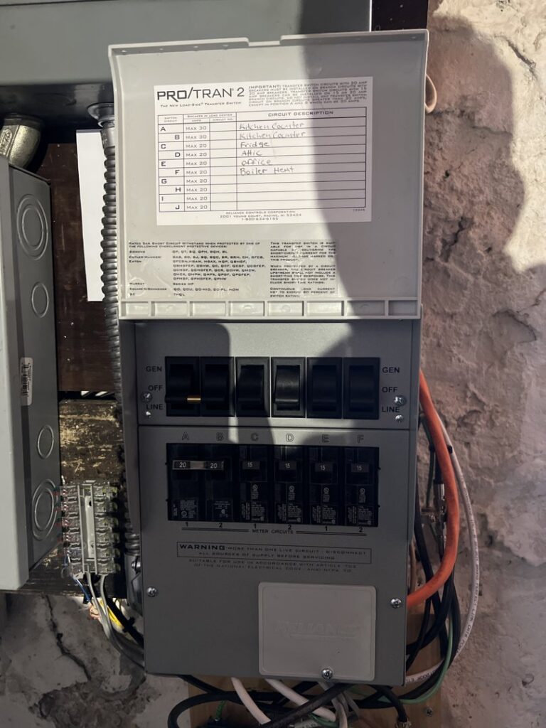 Multiple electrical panels, including a main breaker panel and a transfer switch, installed by Border Electrical Contractor LLC in Nashua, NH.
