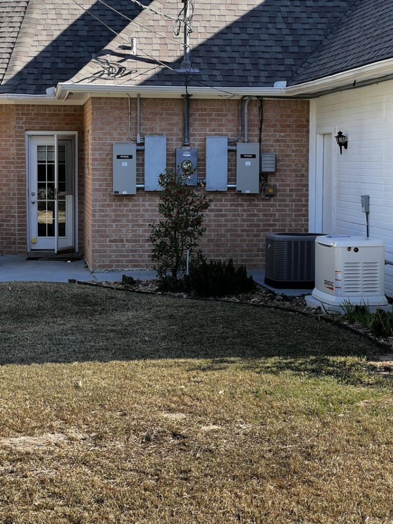 A Generac generator connected to multiple electrical panels on a brick house by Gen Central Power Systems in Houston, TX