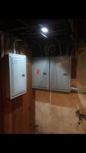 Multiple electrical panels installed in a utility area by John Fean Electrician Inc. in Philadelphia, PA.