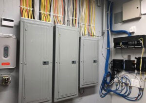 Multiple electrical panels and organized wiring installed in a utility room by T & M Electric Inc in Bismarck, ND