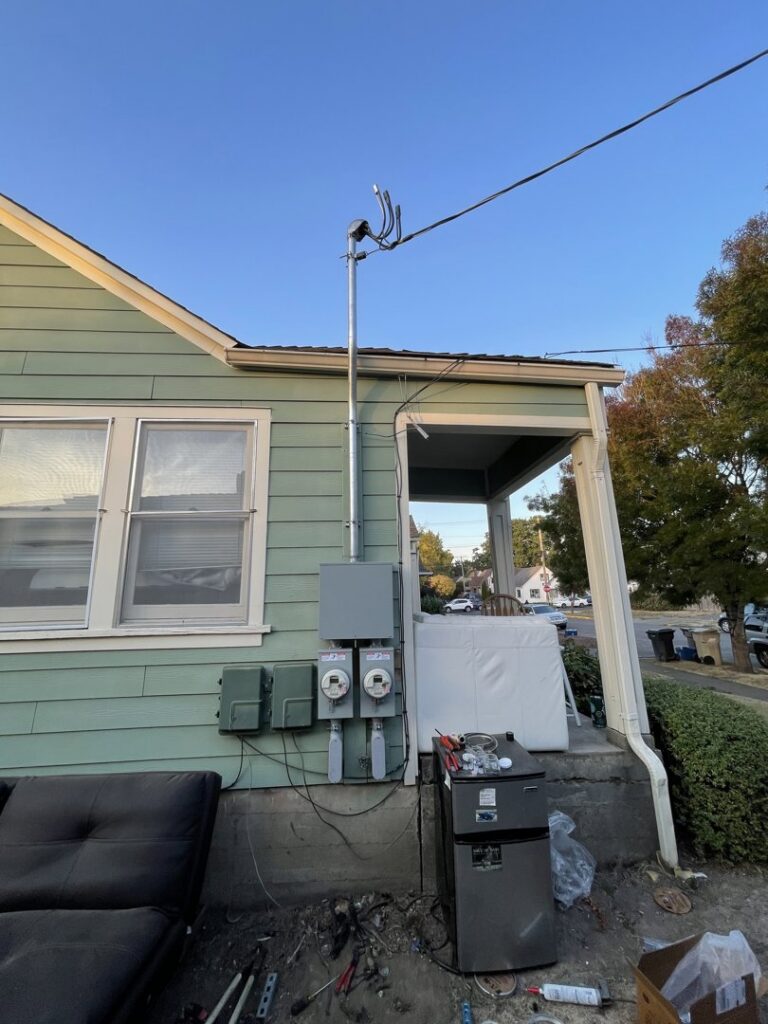 Multiple exterior electrical meters and service panels installed on a house by Freedom Electric Construction, LLC in Eugene, OR.