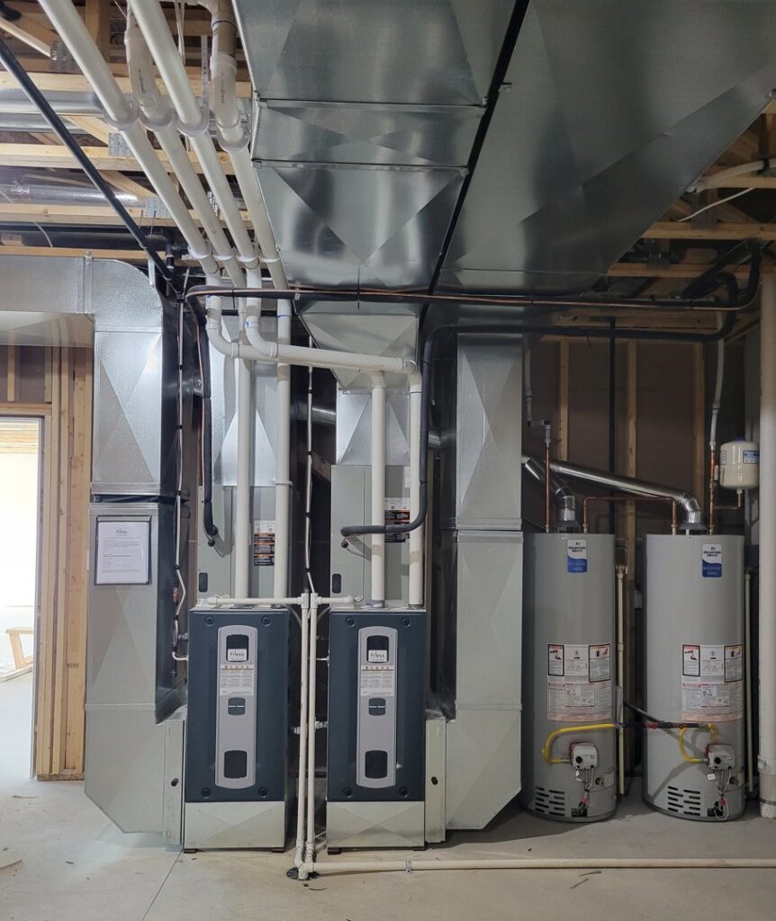 A complex HVAC installation with multiple furnaces, water heaters, and ductwork by Friess Heating & Air Conditioning in Topeka, KS
