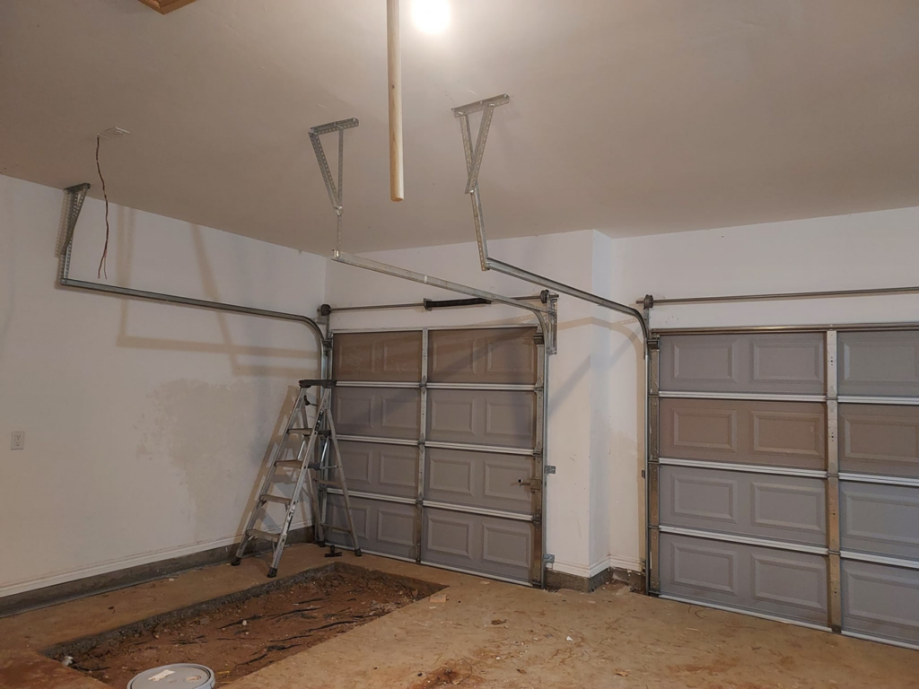 A job site showing multiple garage doors being installed by Zee's Garage Doors in Oklahoma City, OK.