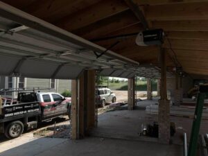 Interior view of a garage with multiple installed garage doors and a service truck from Rose Quality Garage Doors in Murfreesboro, TN