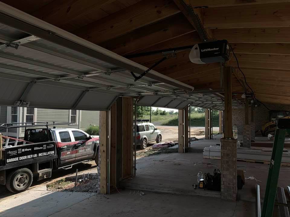 Interior view of a garage with multiple installed garage doors and a service truck from Rose Quality Garage Doors in Murfreesboro, TN