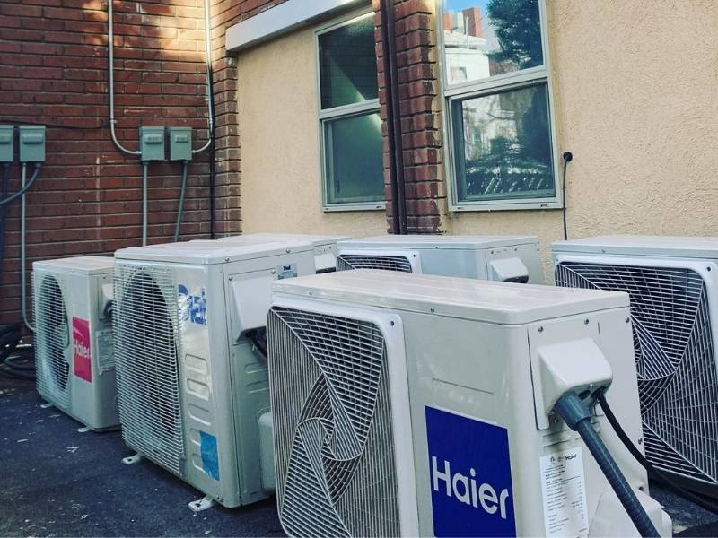 Multiple Haier mini-split air conditioning units installed on the exterior wall of a building by EA Heating & Cooling in El Paso, TX.