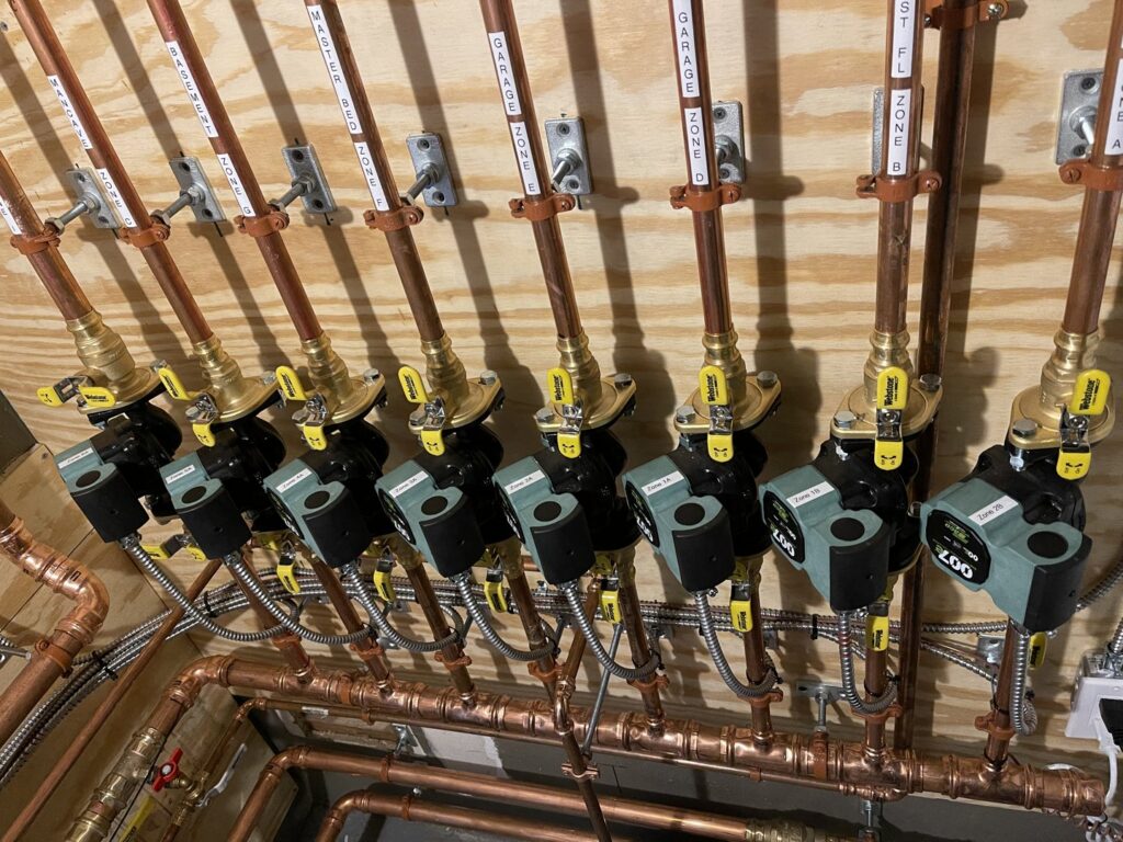 Multiple heating zone circulator pumps and copper piping for various zones installed by Evergreen Services in Warwick, RI.