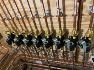 Multiple heating zone circulator pumps and copper piping for various zones installed by Evergreen Services in Warwick, RI.