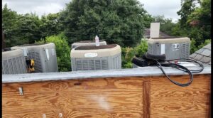 Multiple outdoor HVAC condenser units installed on a rooftop, serviced by Harlen Johnson Heating & Air in Dallas, TX.