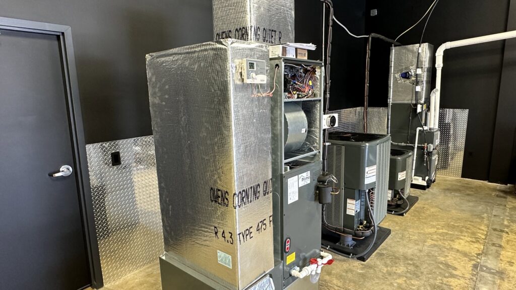 A row of various HVAC furnace and air handler units, showcasing the range of systems handled by Prime Home HVAC in York, PA.