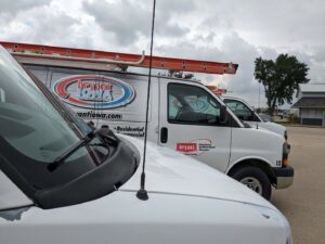 Multiple branded HVAC service vans parked for Marie Keding Bryant Iowa Heating and Cooling in Ankeny, IA.