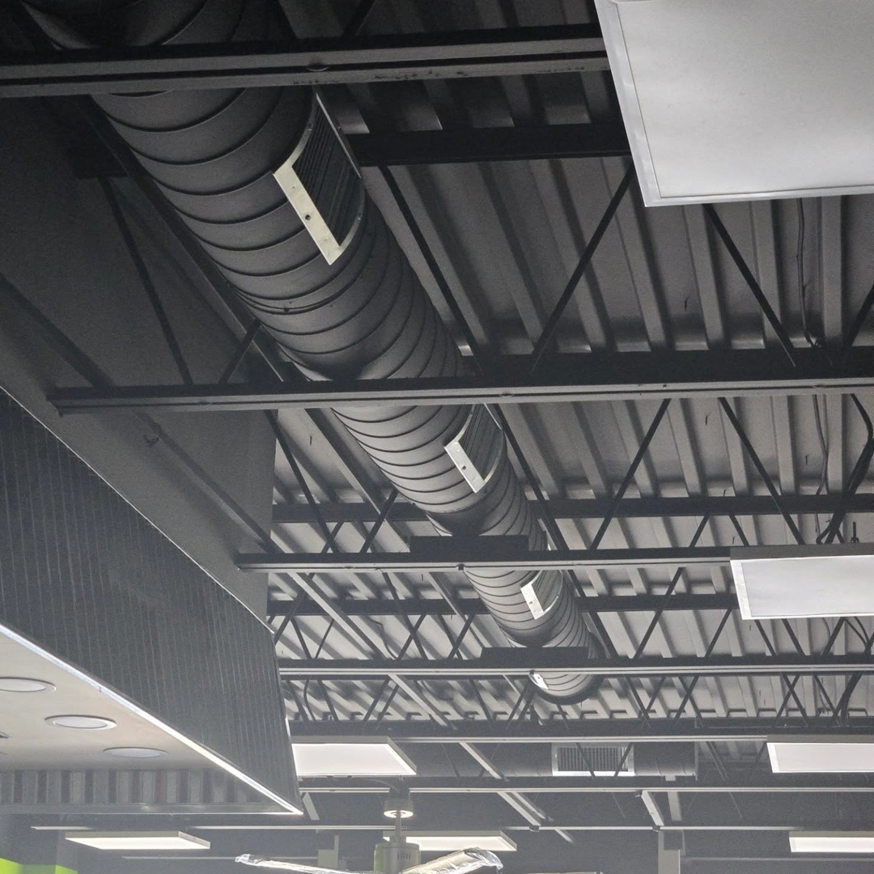 Multiple HVAC spiral ducts and vents installed in a commercial ceiling by Pepeta Service Inc. in Clayton, DE