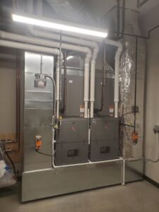 Multiple indoor furnace and air handler units with ductwork installed by Advantage Mechanical, Inc. in Appleton, WI.