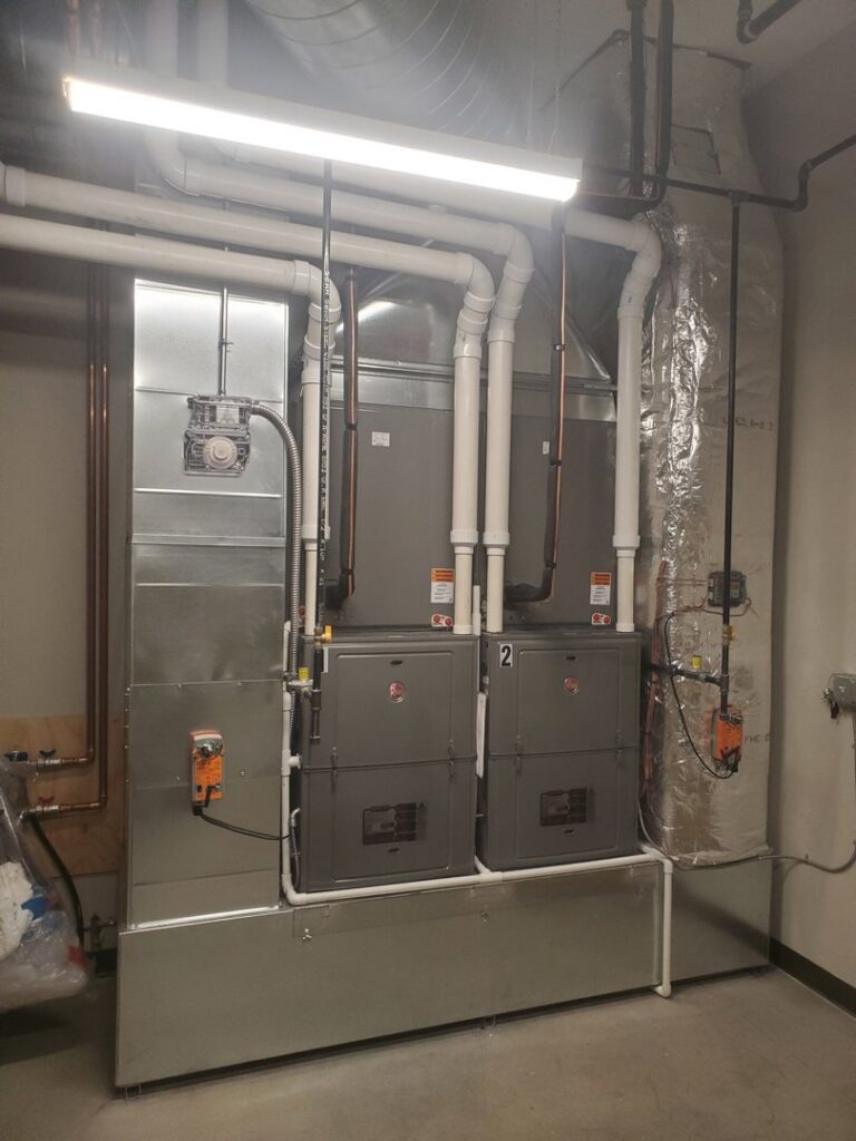 Multiple indoor furnace and air handler units with ductwork installed by Advantage Mechanical, Inc. in Appleton, WI.