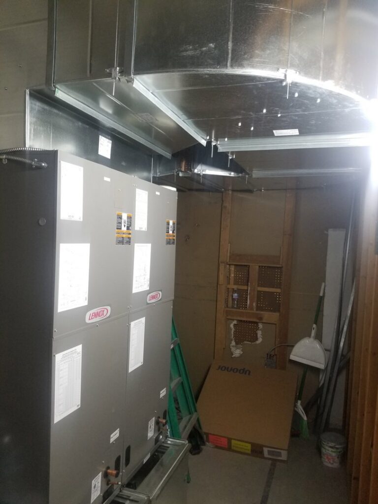 Multiple Lennox HVAC units and extensive ductwork installed in a utility room by D & D Heating & Air in Brighton, CO.