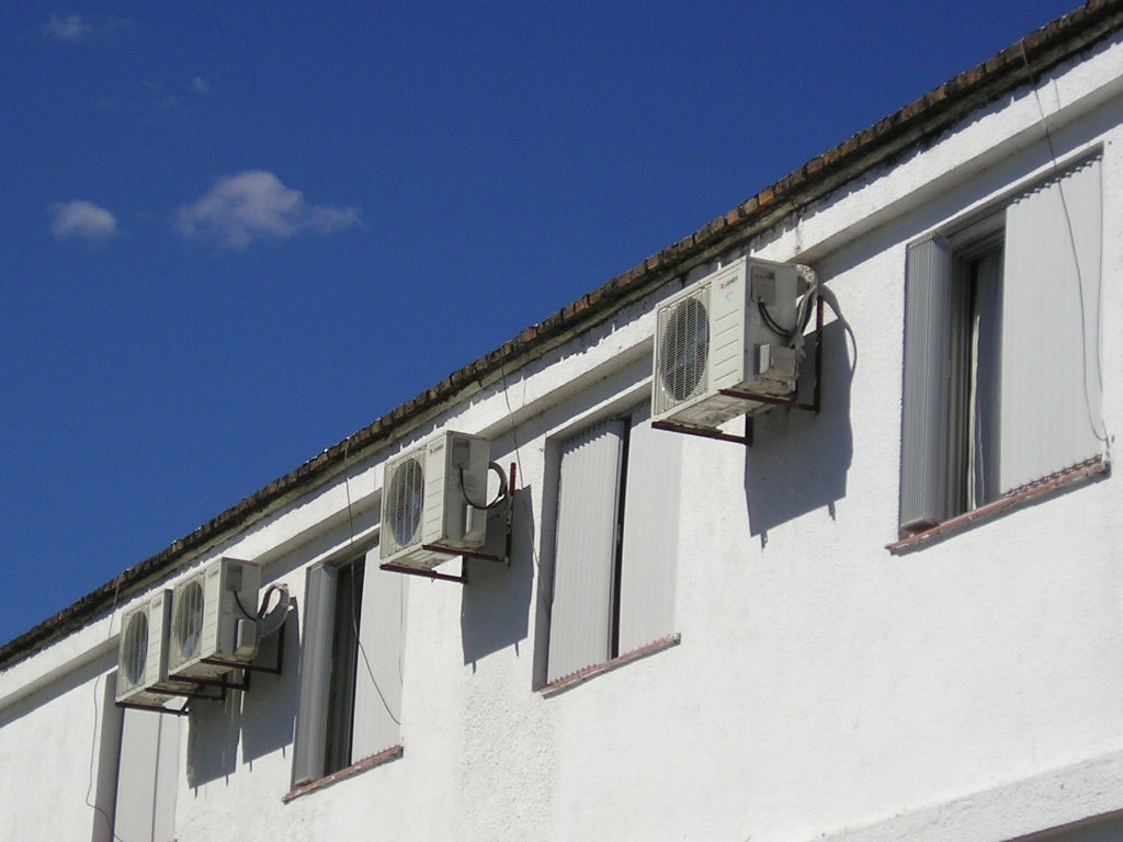 Multiple mini-split outdoor HVAC units installed on the side of a commercial building by Trenary Service Company in Martinsburg, WV.