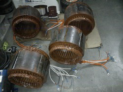 Multiple electric motor stators in a workshop, prepared for or undergoing rewinding by Alexco Max Electricals And Construction in Madina, GH.