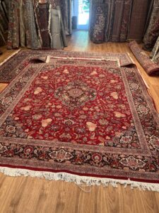 Multiple vibrant oriental rugs laid out for display in the showroom of Borokhim's Oriental Rugs in Madison, WI.