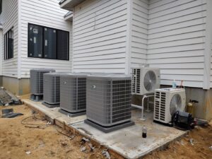 Installation of multiple outdoor AC condenser units at a new construction site by Ambiaire in Lakewood, NJ