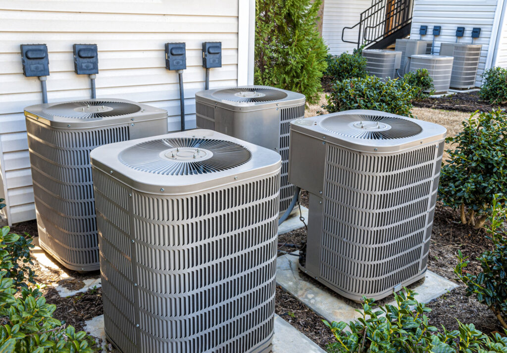 Multiple outdoor AC condenser units installed outside a building by Simple Valley Heating and Cooling in Orem, UT