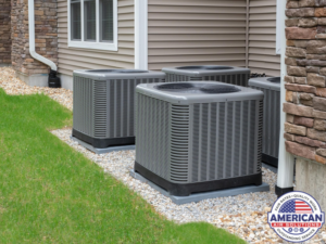 Several outdoor air conditioning units installed next to a residential building, serviced by American Air Solutions in Summerville, SC.