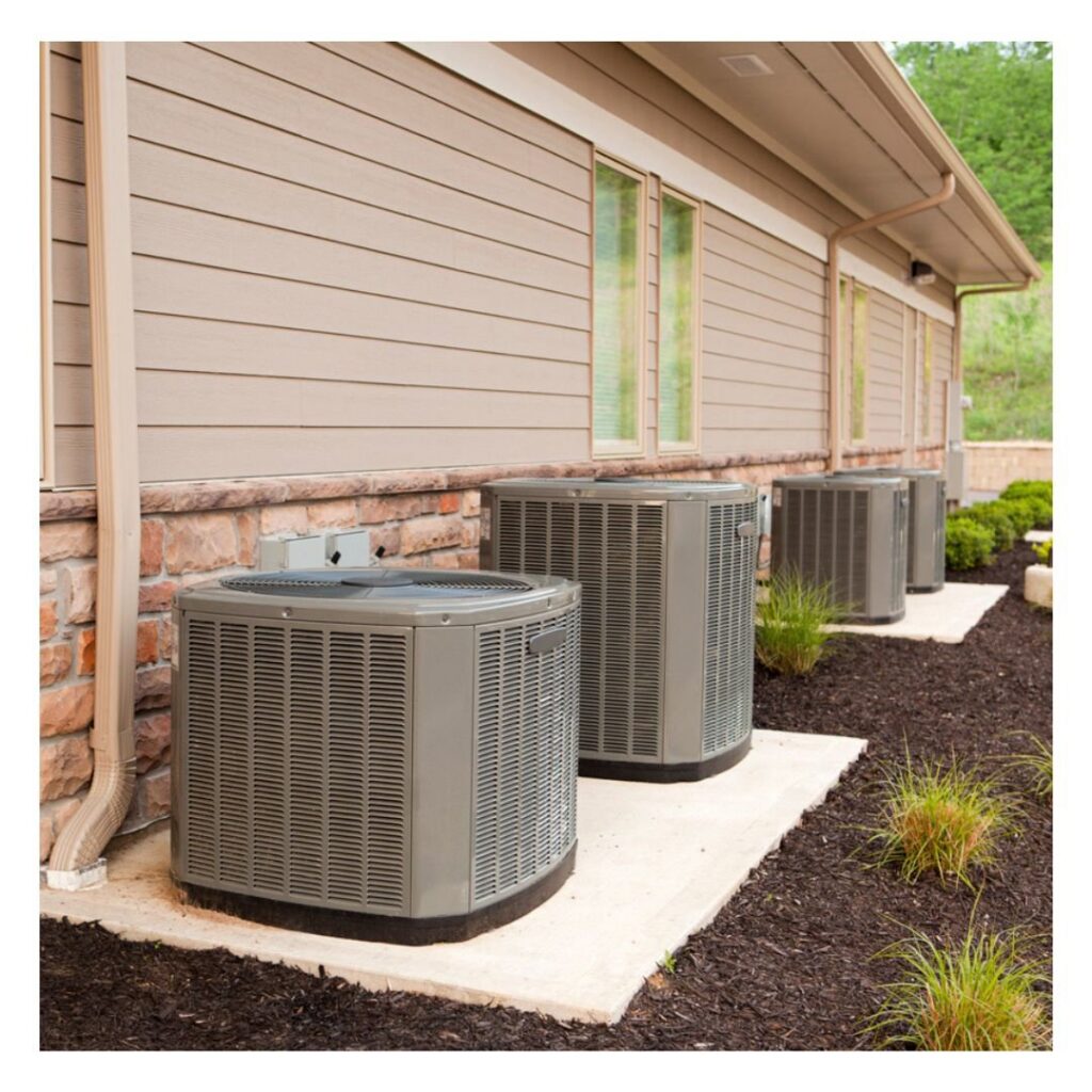 Multiple outdoor AC condenser units installed along the side of a commercial building by Competition A/C & Heat, LLC in Corpus Christi, TX