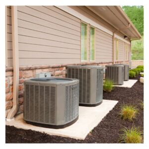 Multiple outdoor AC condenser units installed along the side of a commercial building by Competition A/C & Heat, LLC in Corpus Christi, TX