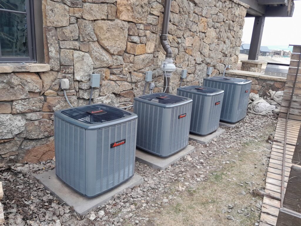 Four outdoor commercial or large residential air conditioning units installed by Ridgeline Heating and Cooling in Idaho Falls, ID.