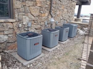 Four outdoor commercial or large residential air conditioning units installed by Ridgeline Heating and Cooling in Idaho Falls, ID.