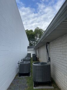 Multiple outdoor air conditioning units installed along a commercial building by Brothers HVAC LLC in Owings Mills, MD