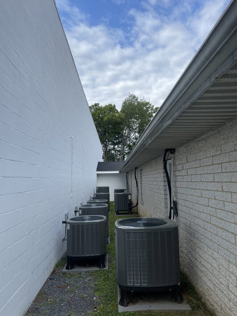 Multiple outdoor air conditioning units installed along a commercial building by Brothers HVAC LLC in Owings Mills, MD