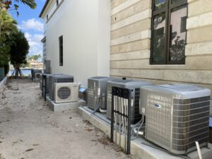 Multiple outdoor air conditioning units installed along the side of a building by T&D Air Conditioning in Fort Lauderdale, FL.