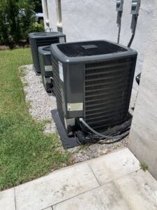 Three outdoor air conditioning units installed next to a building by Get RiTe A/C & Heating in Madisonville, LA.